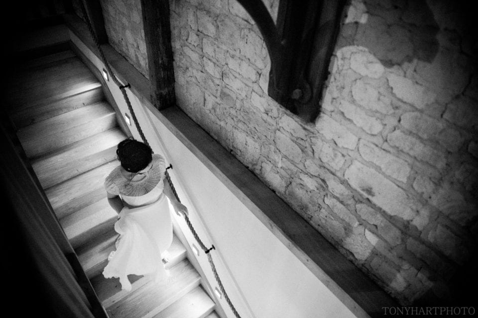Bury Court Barn wedding - Bride on the staircase