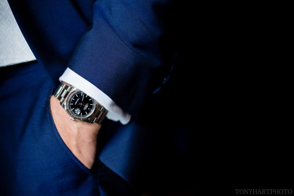 Groom's Rolex watch and blue suit