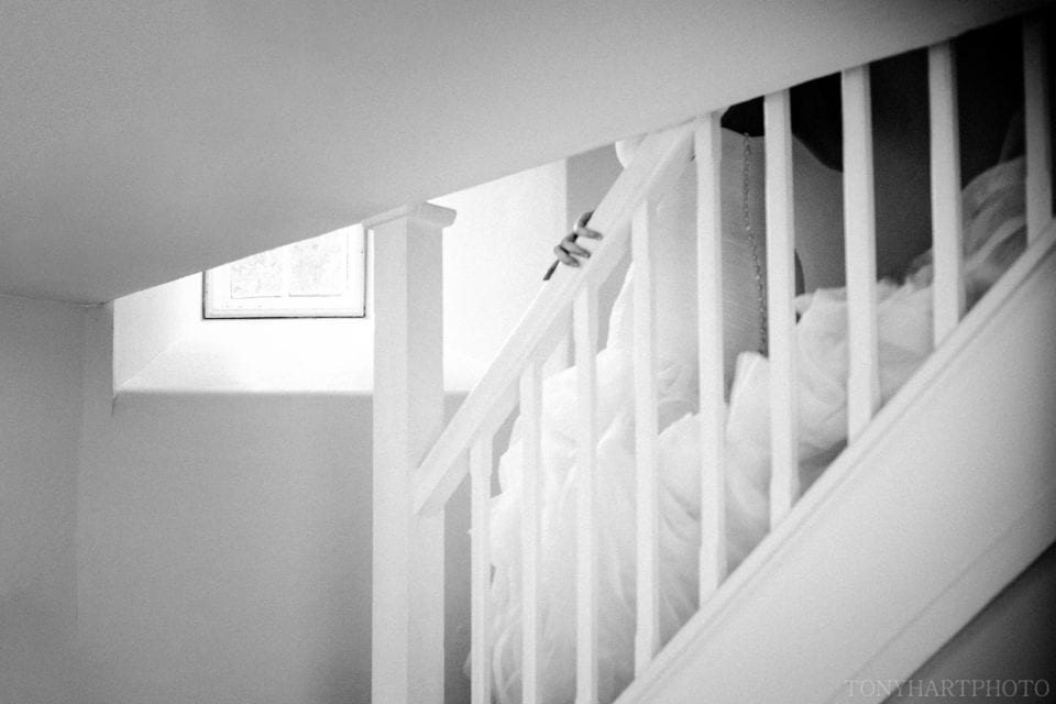Bride descending the stairs in the Gatehouse at Farnham Castle