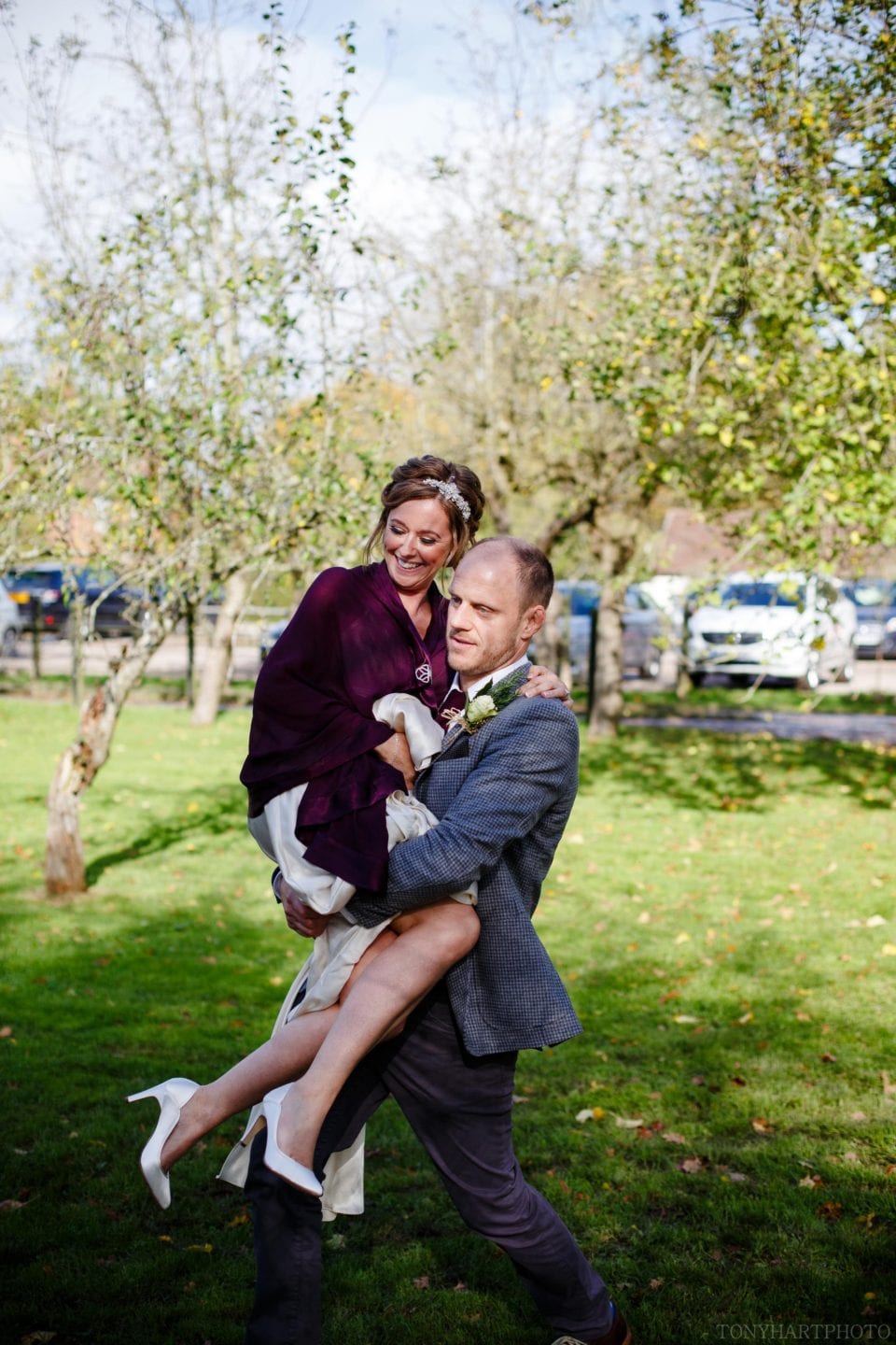 West Green House Wedding - Tom carries his new wife Emma into the wedding reception