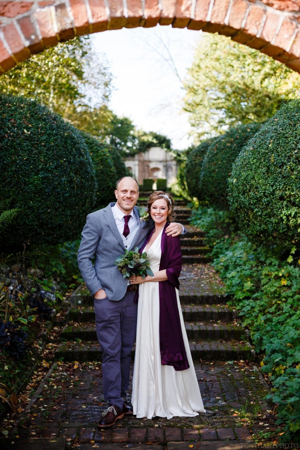 Bride & Groom in the circular archway during their West Green House wedding