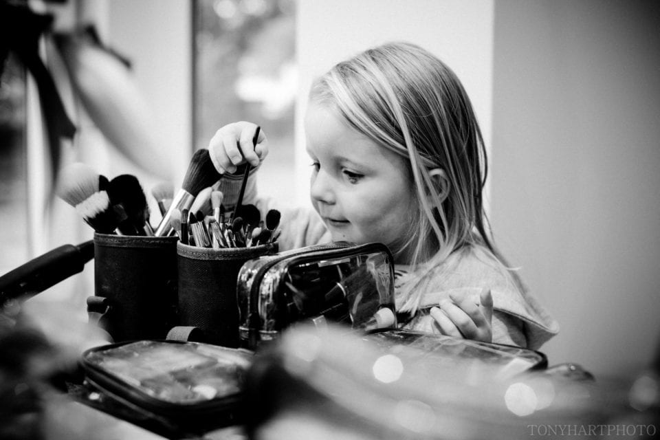 Flowergirl searching through the Makeup brushes