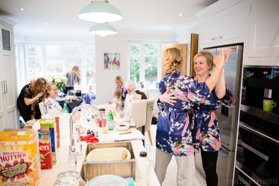 Bridesmaids dancing in the kitchen