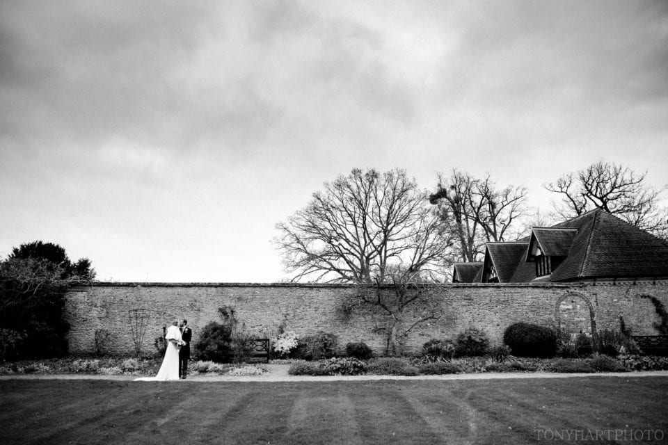Wide angle portrait of bride and groom Loseley Park