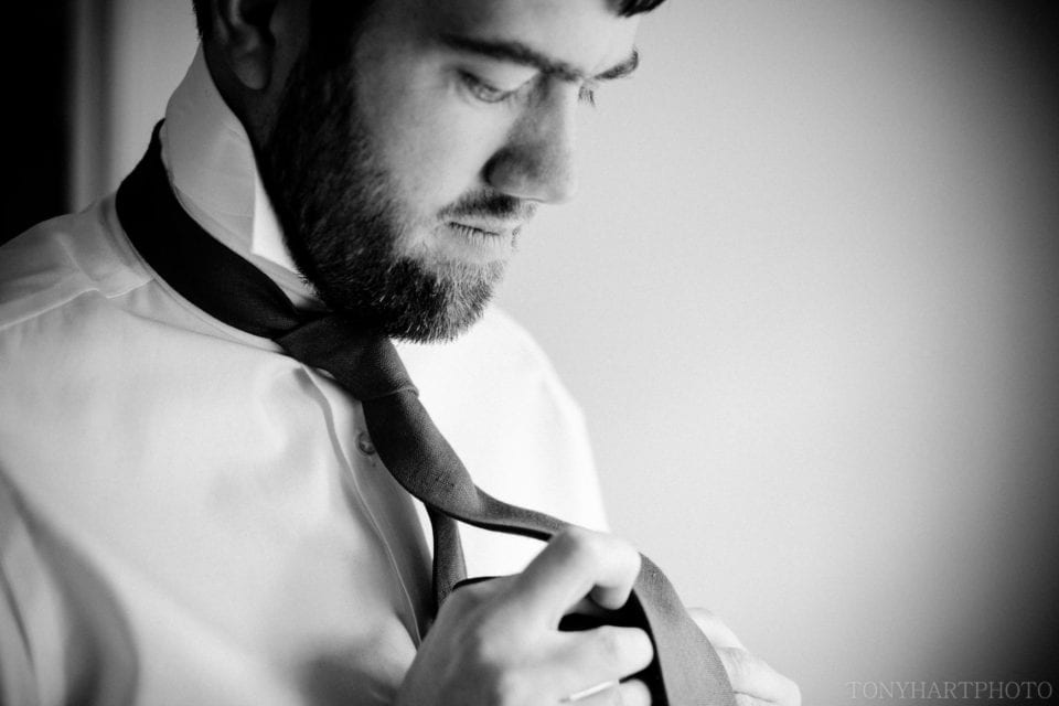 Groom Phil ties his tie