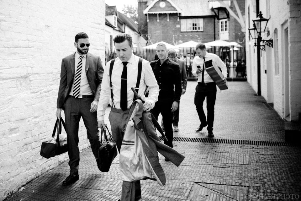 The groom and his groomsmen walk through Henley