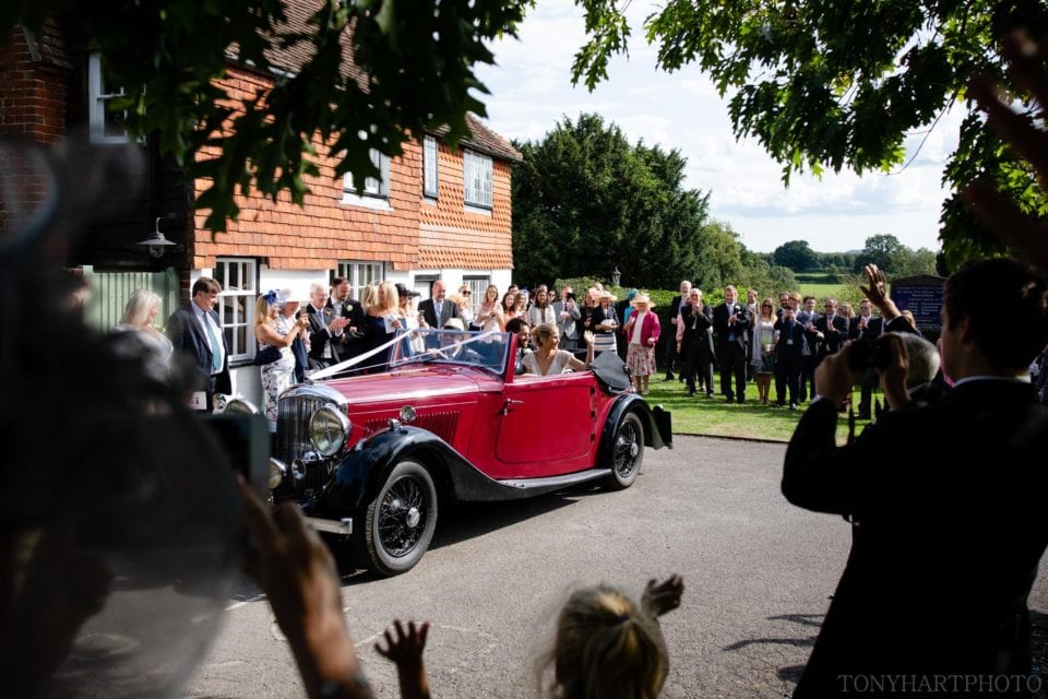 Bride & Groom departing church in vintage Bentley