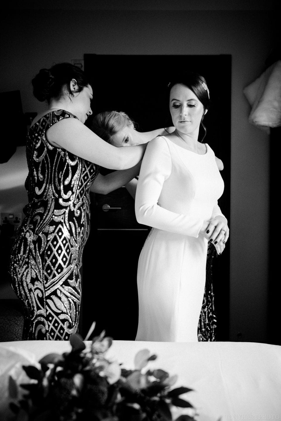 Jemima getting into her dress at Northbrook Park in Farnham