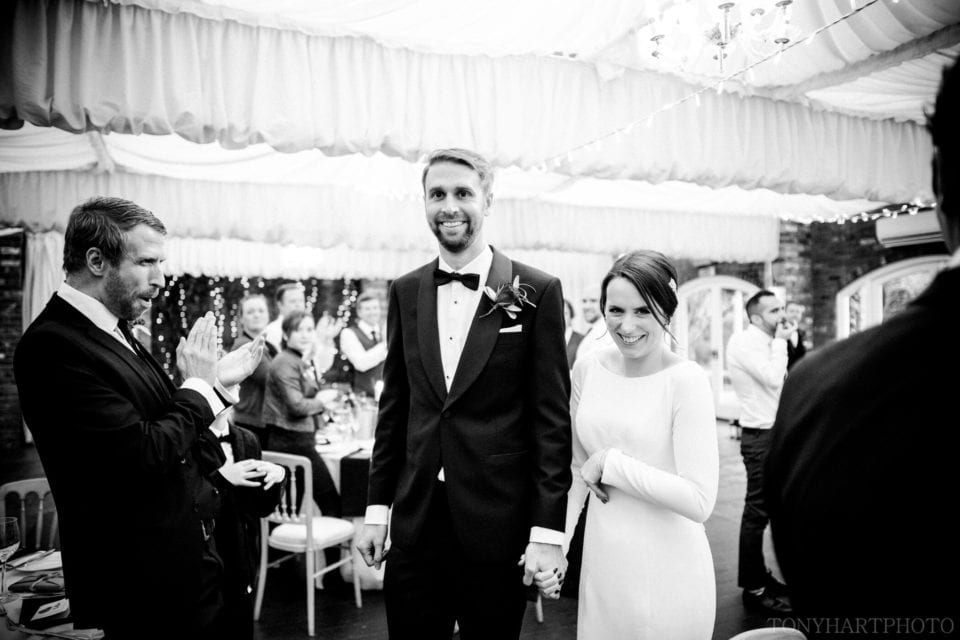Northbrook Park Wedding Photography - James & Jemima making their entrance into their wedding breakfast