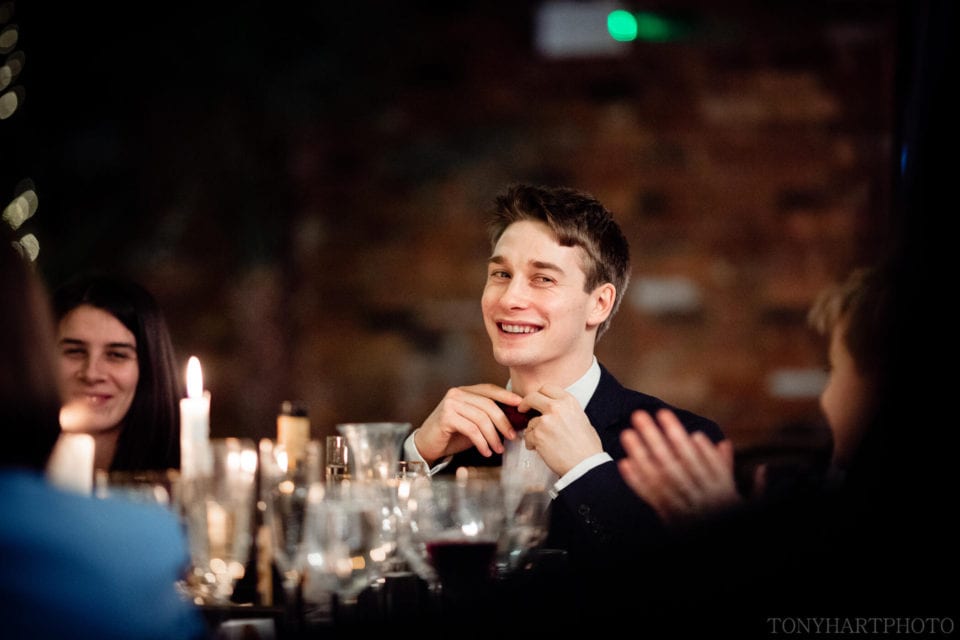 A guest adjusting his bowtie