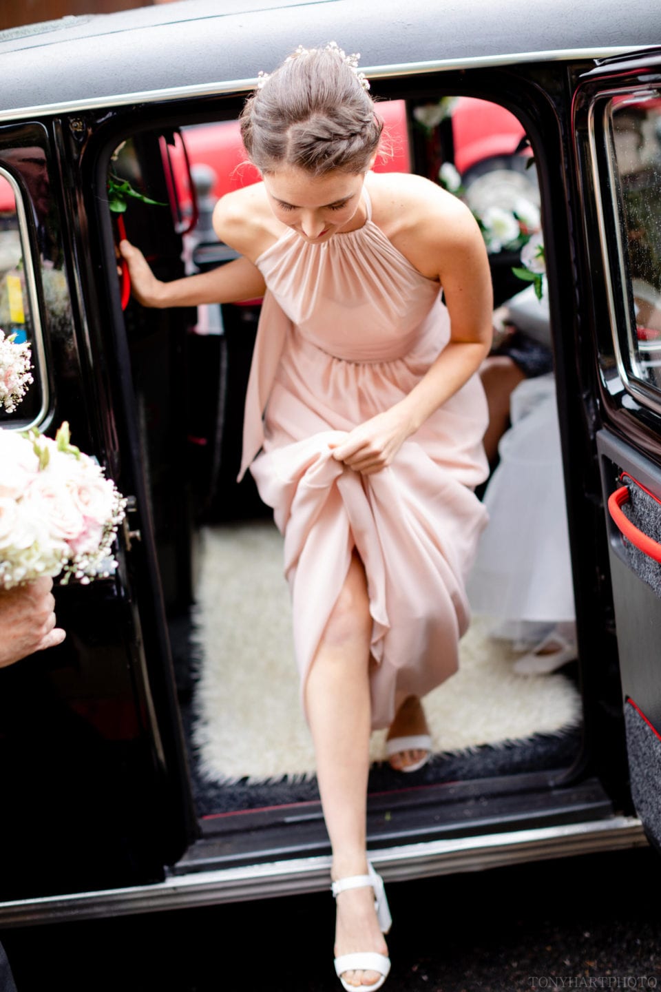 Bridemaids stepping out of the taxi