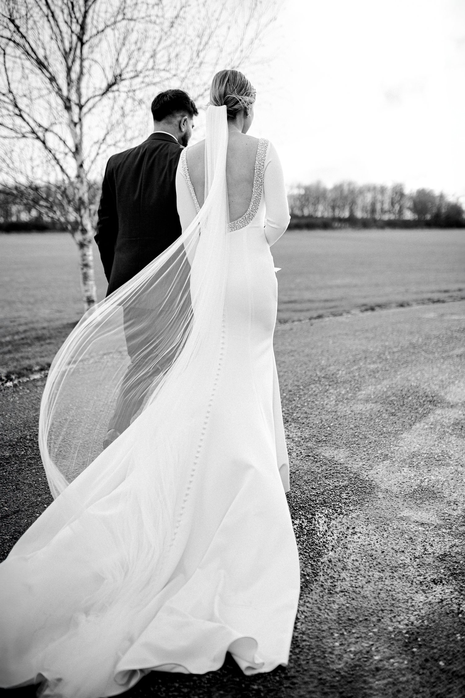 A couple walk together during their Winter Wedding at Stratton Court Barn
