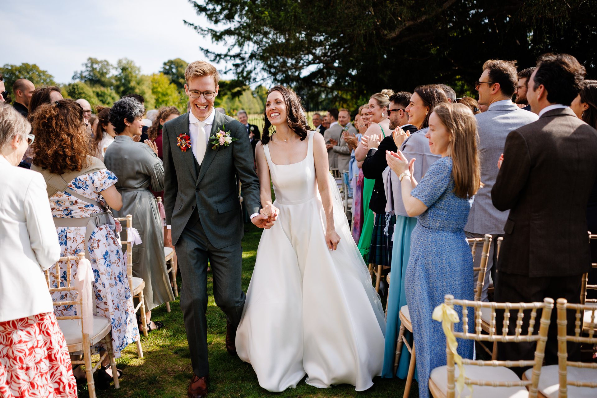 A Bride & Groom walk but up the aisle, newly married during their West Horsley Place wedding.